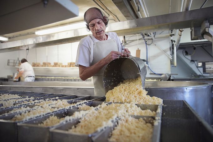 John Christopherson pours Brick cheese curds into forms at the Widmer's Cheese Cellars on June 27, 2016 in Theresa, Wisconsin.