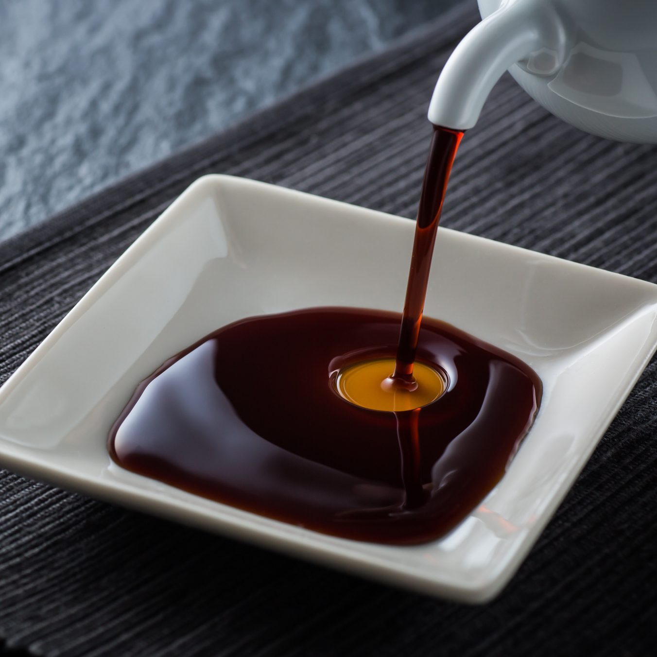Pouring soy sauce into dish