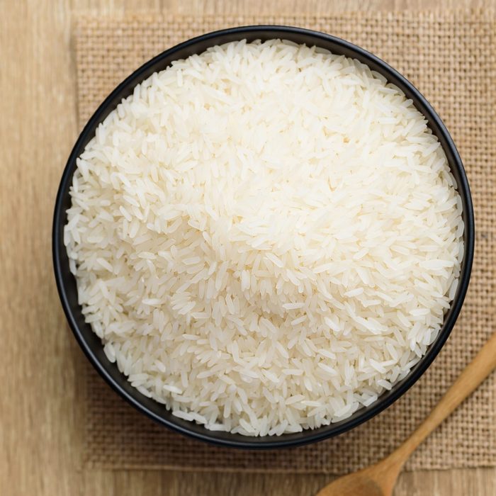 Organic Thai Jasmine rice grain in bowl on wood table