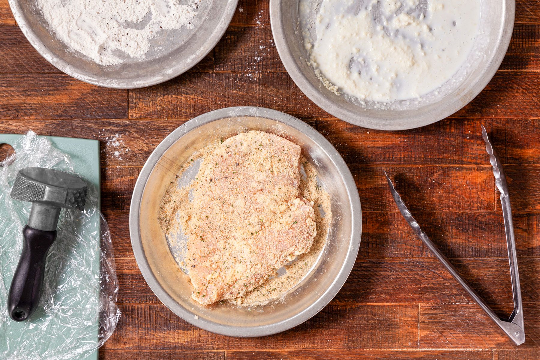 Chicken Coated with Bread Crumbs in a Steel Plate on Wooden Surface