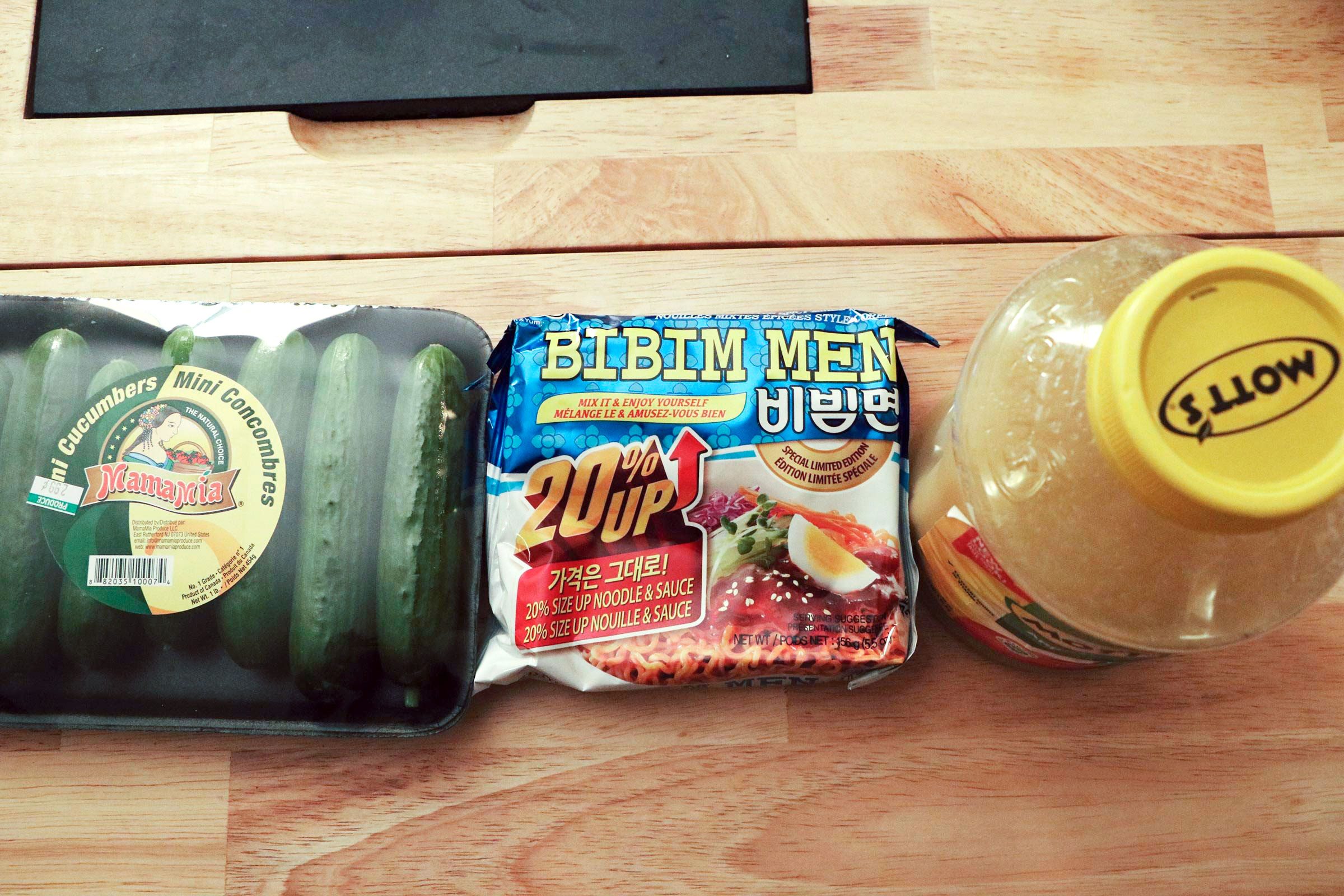 Ramen noodle package with apple sauce and package of cucumbers