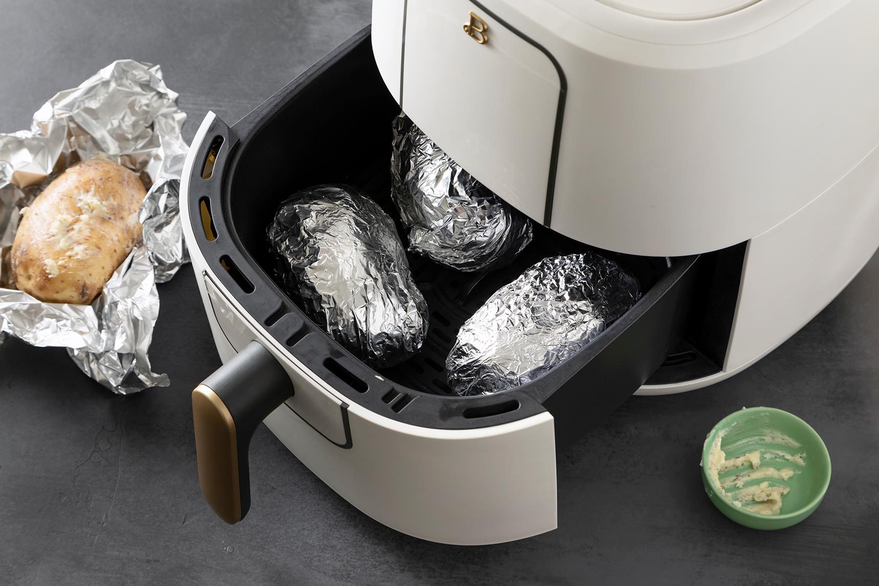 Aluminum Foil wrapped Potatoes in a Air-Fryer Basket