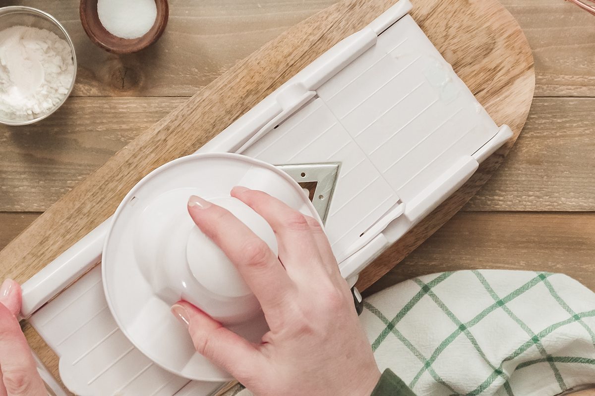 Slicing Organic Gold Potatoes On A V Blade Mandoline To Prepare