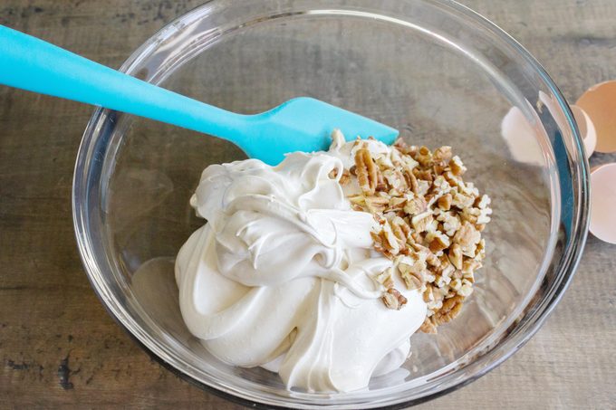 mixing ingredients in a clear glass bowl for delta bars