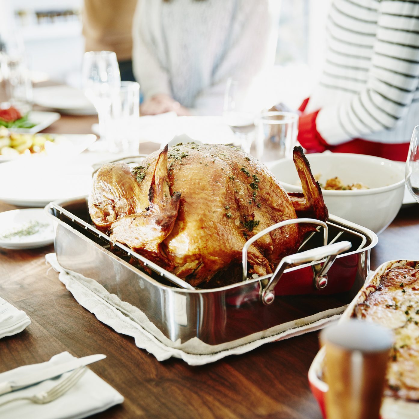 Turkey in roasting pan on table for holiday meal