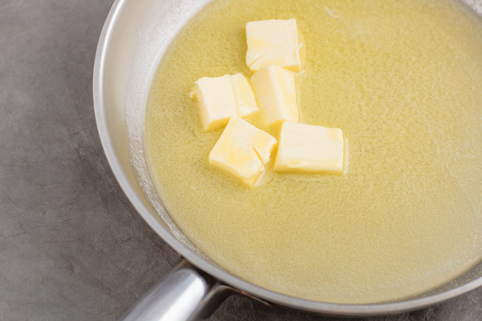 Chopped butter in silver skillet.