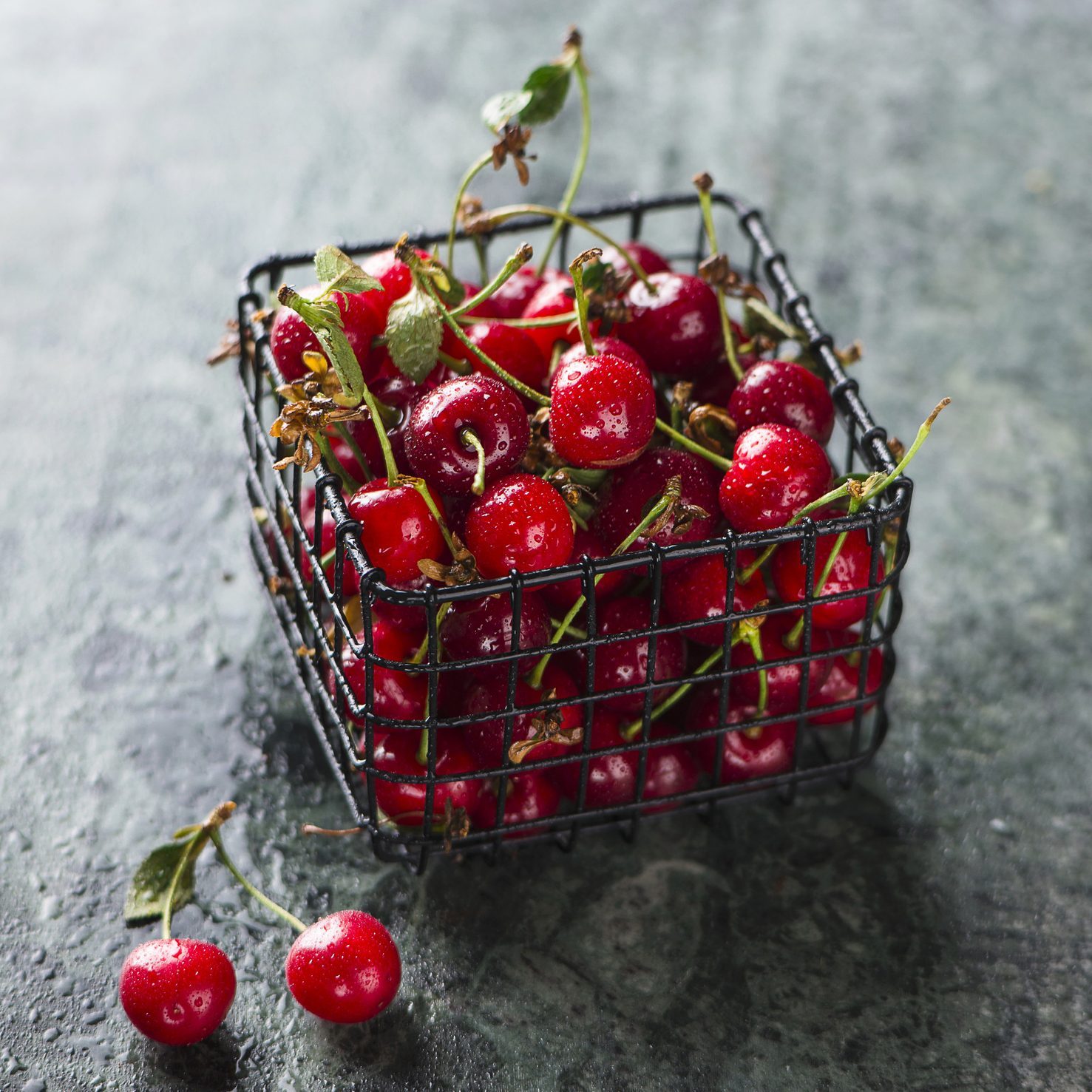 Sour cherries in a small wire basket