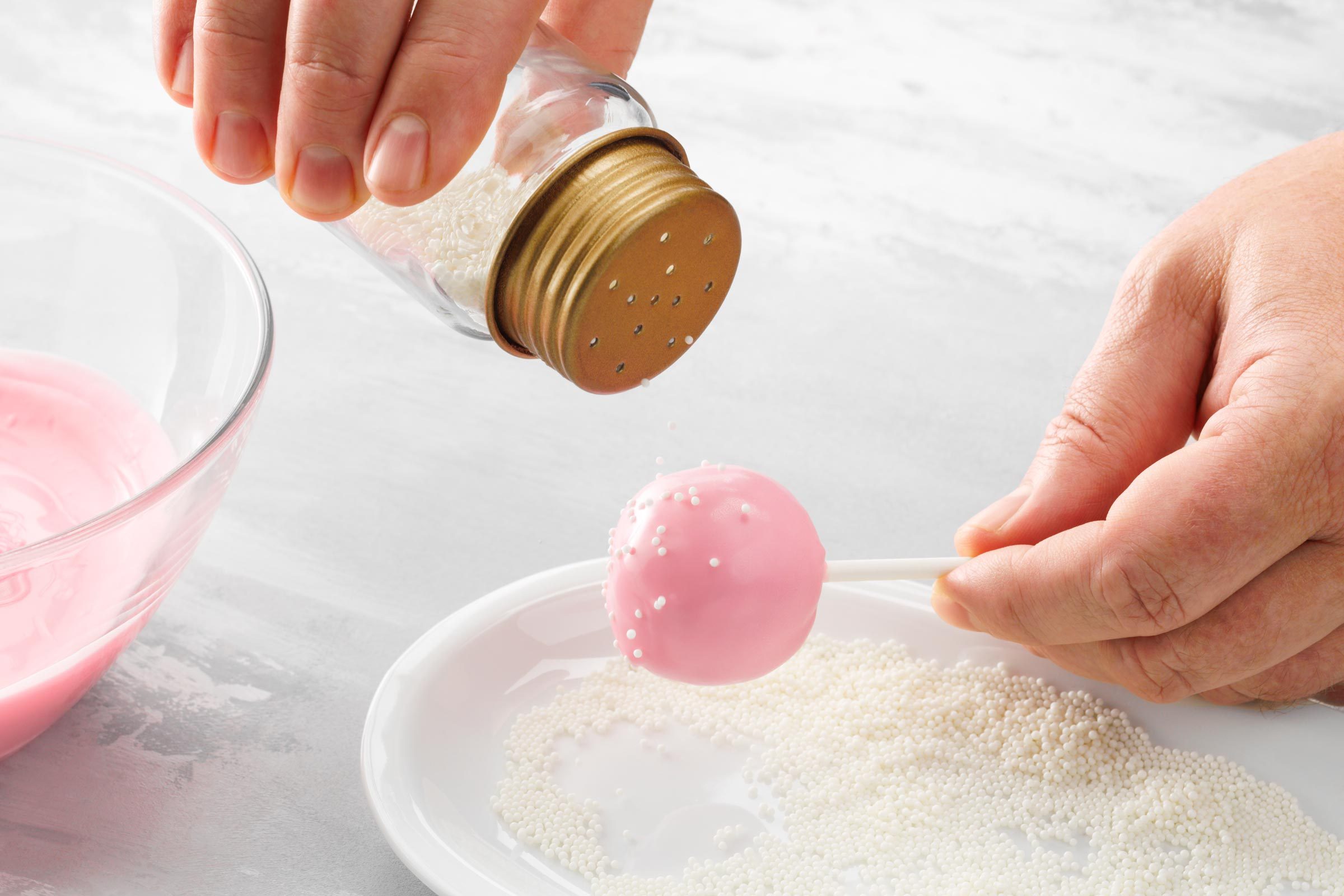 putting sprinkles on cake pop