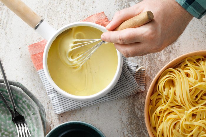 staring sauce with a whisk