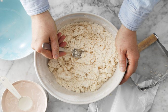 Pizza Rustica Easter Pie stueeing ingredients in bowl
