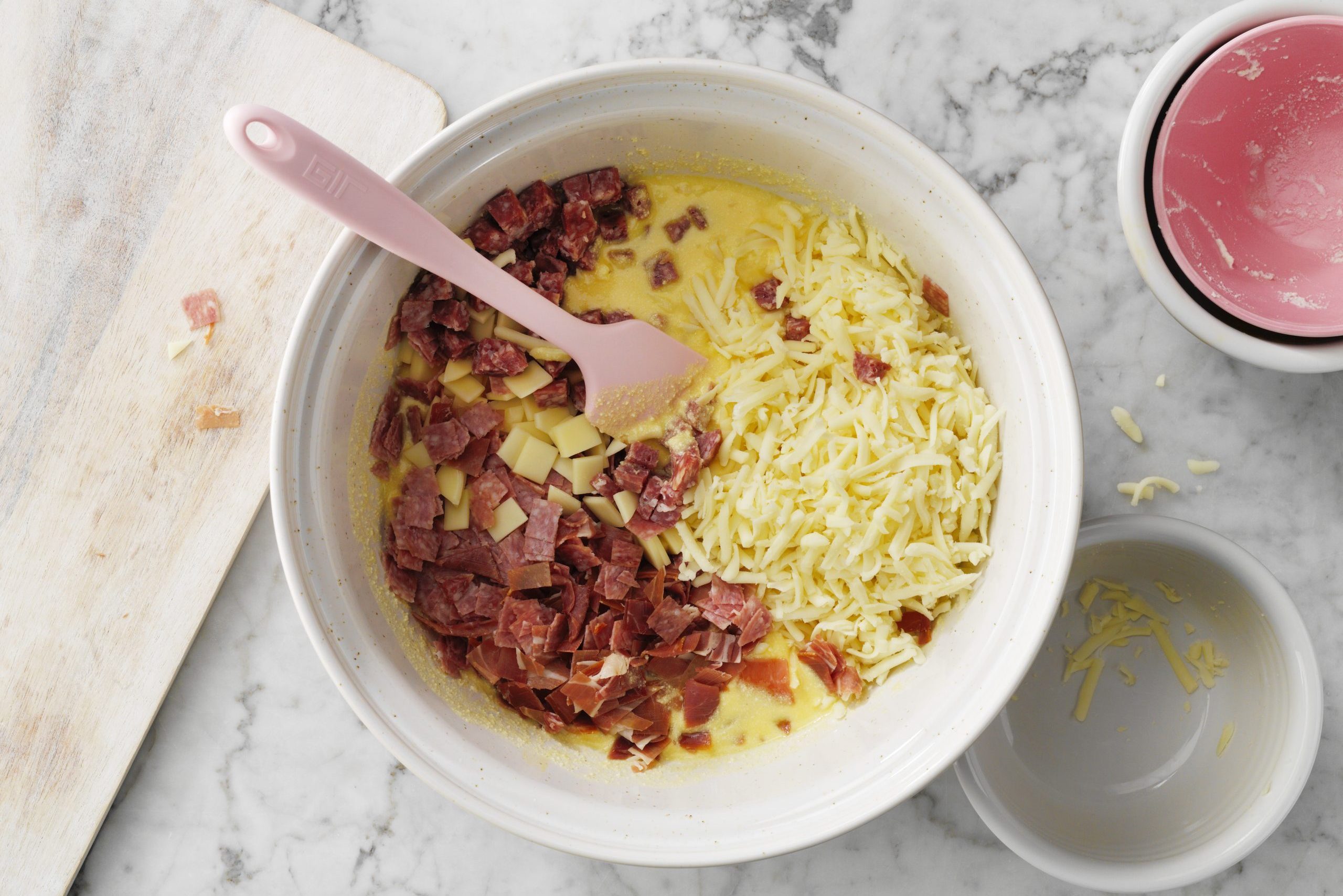 Pizza Rustica Easter Pie mixture in bowl with spoom