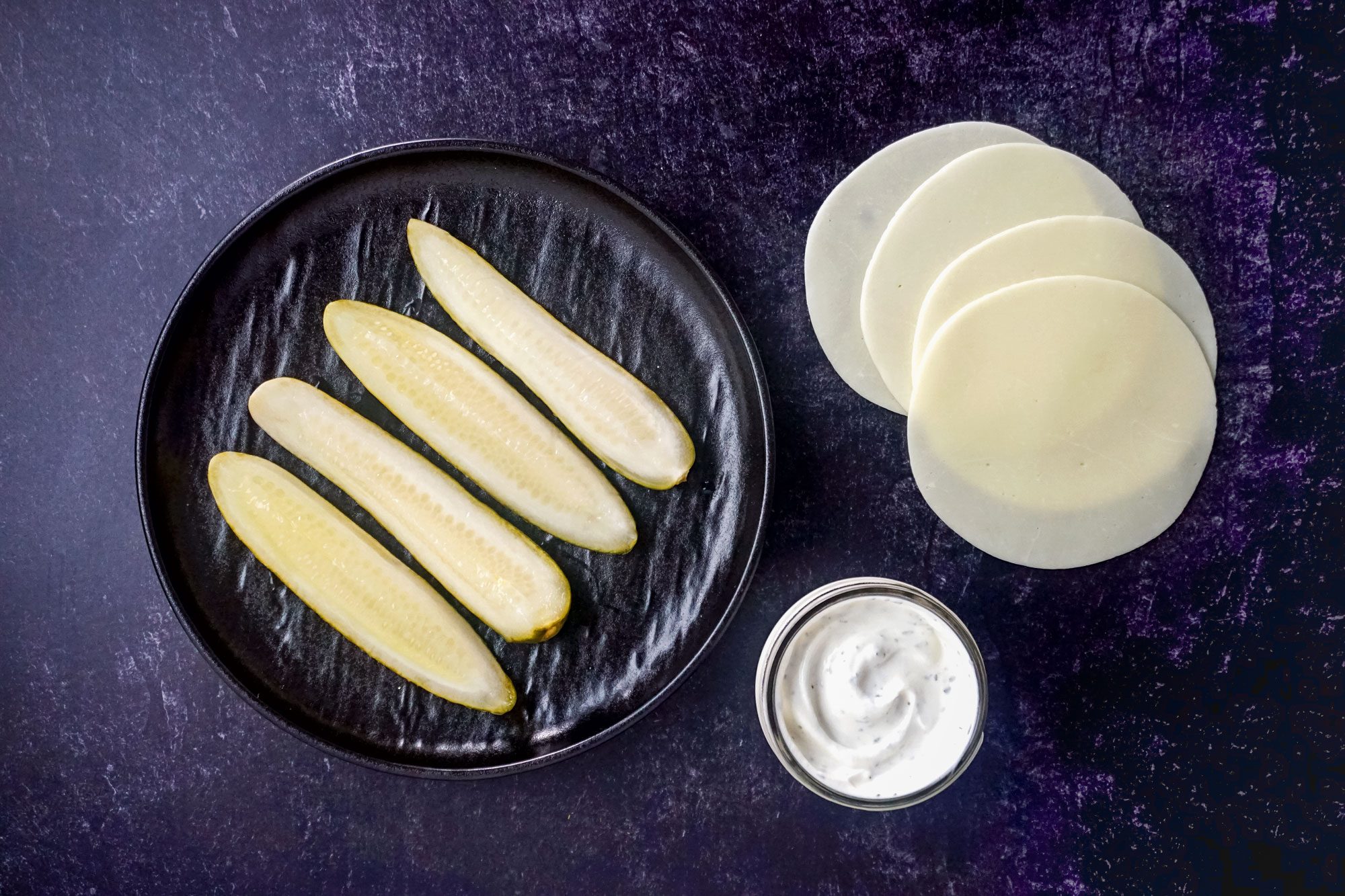 Ingredients for Cheese Wrapped Pickle on Marble surface