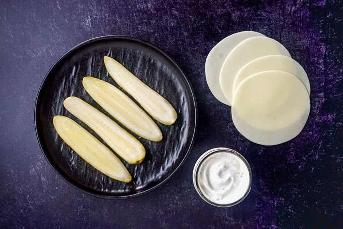 Ingredients for Cheese Wrapped Pickle on Marble surface