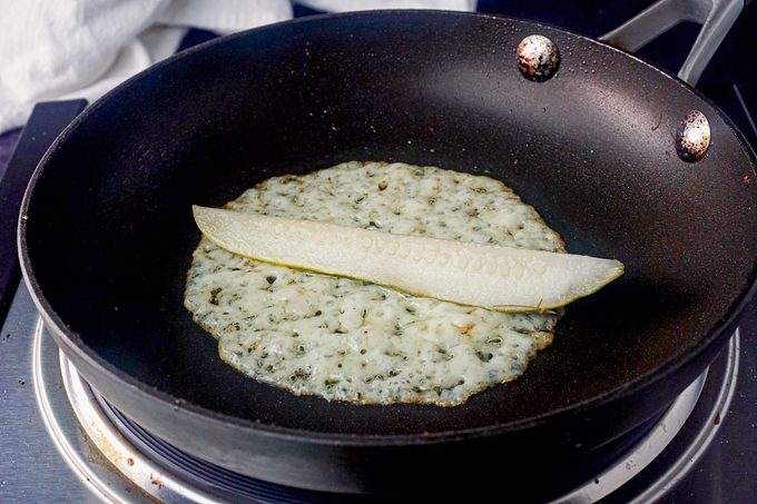 Pickle and Cheese Slice frying in pan