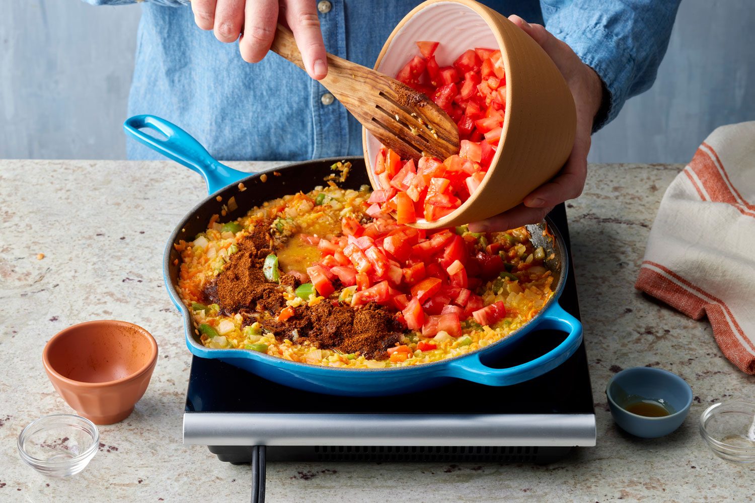 adding the chopped tomatoes into the vegan sloppy joes mixture