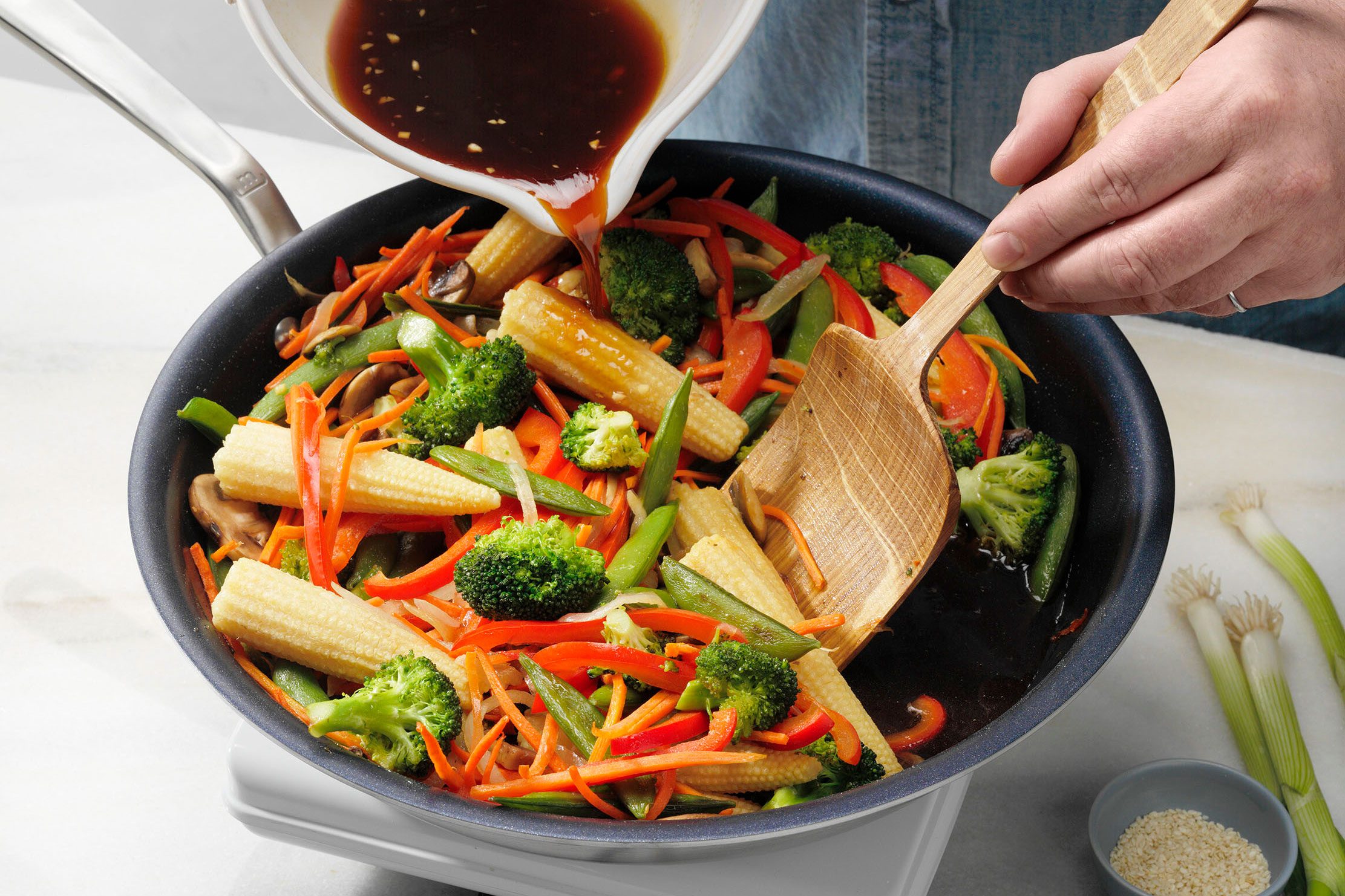 adding sauce to the stir fry