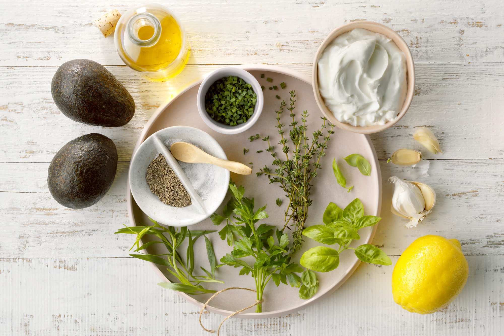 Green Goddess Dip ingredients arranged on a white wood surface