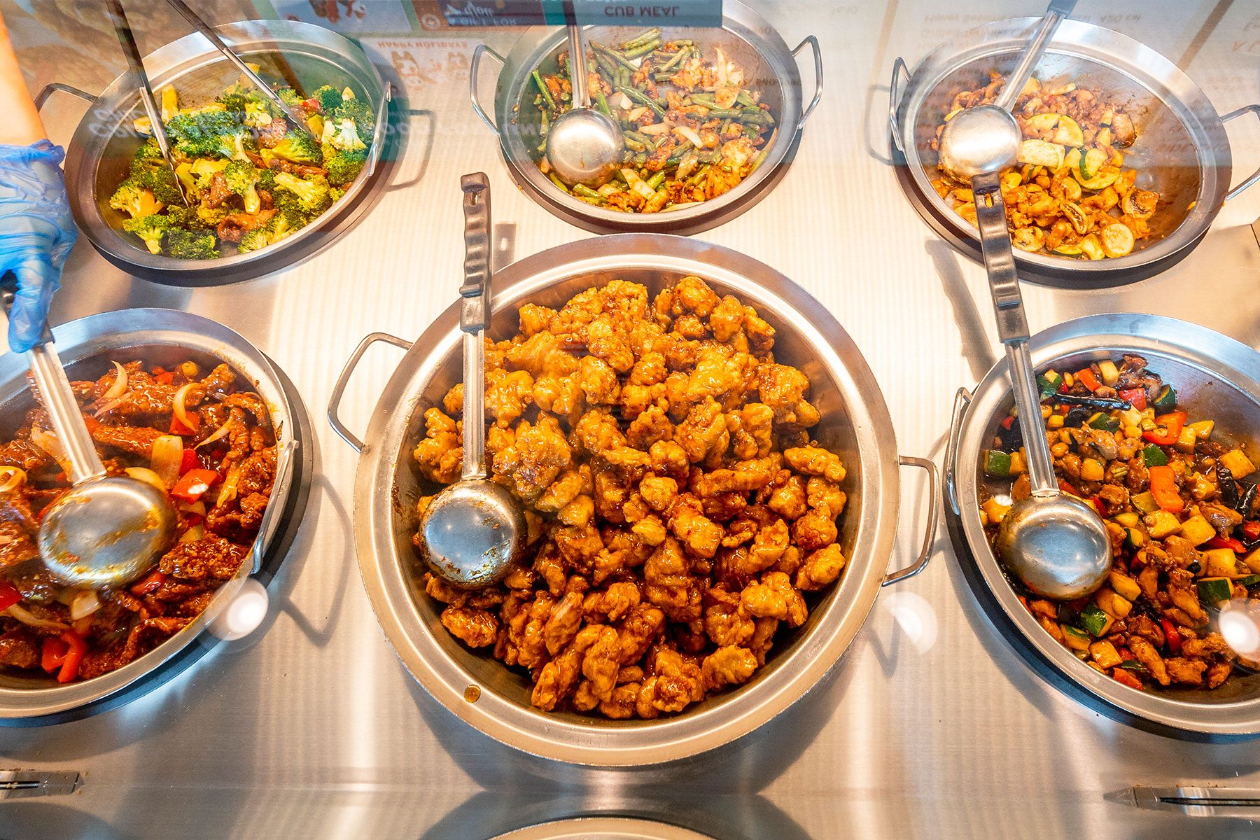 Food Rests under a glass countertop at a Panda Express Restaurant in Garden Grove, CA