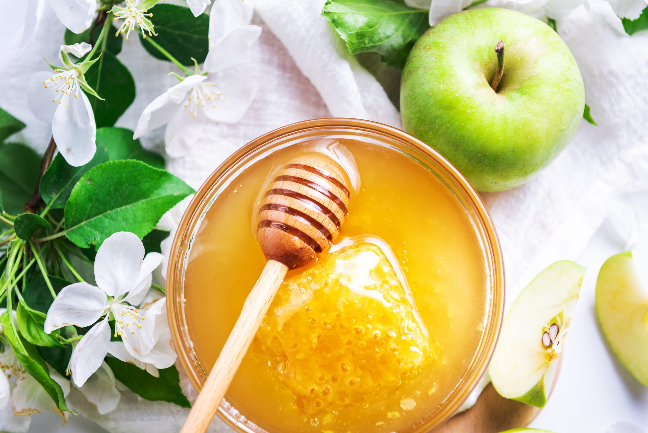 Green apples and honey bowl