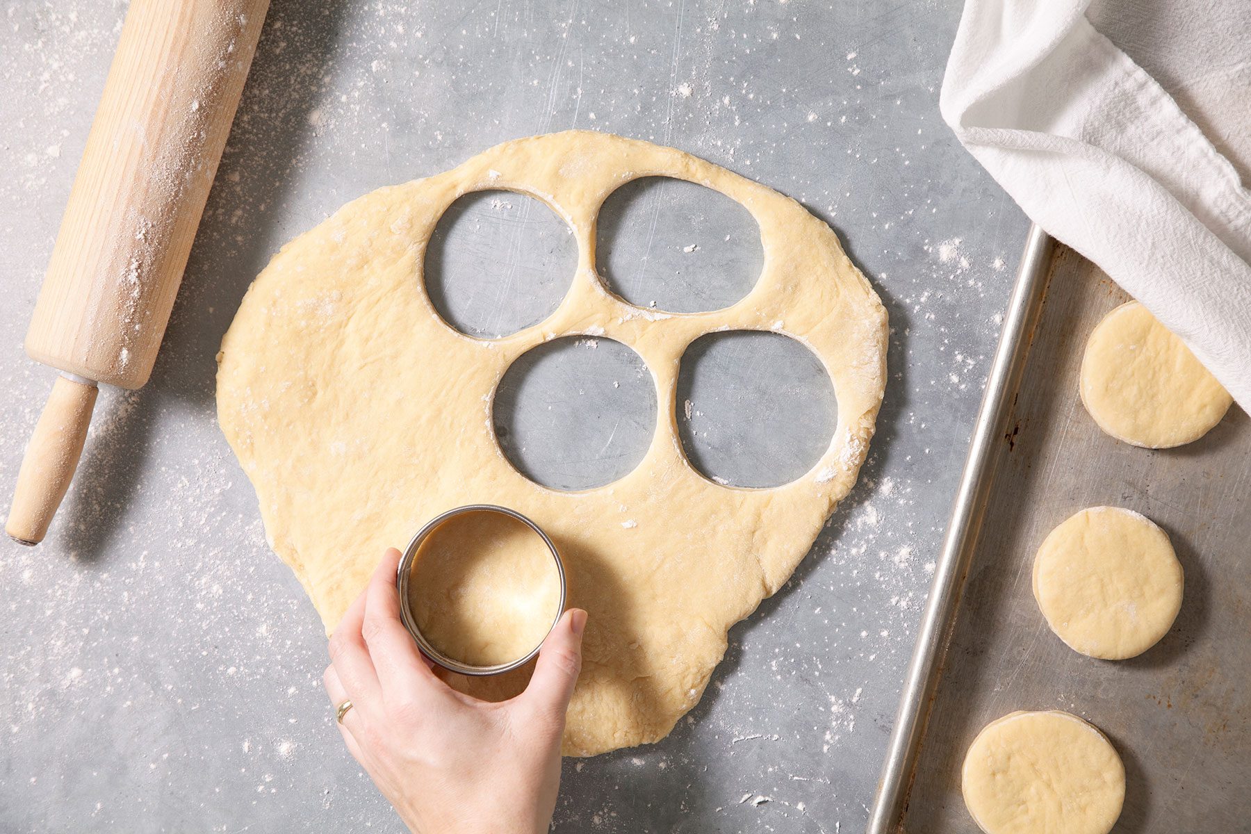 Cutting out doughnuts from dough