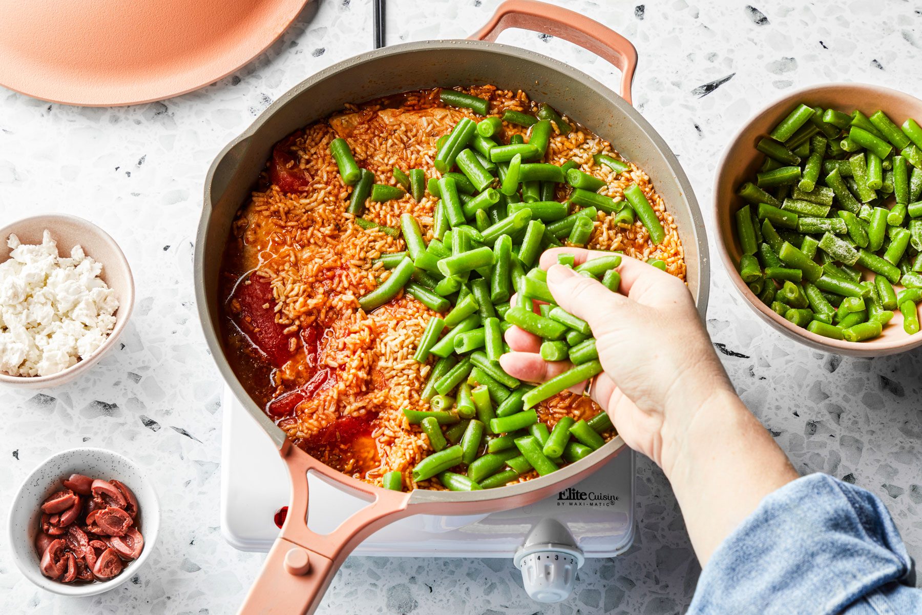 Beans rice and chicken mixed in a large pan 