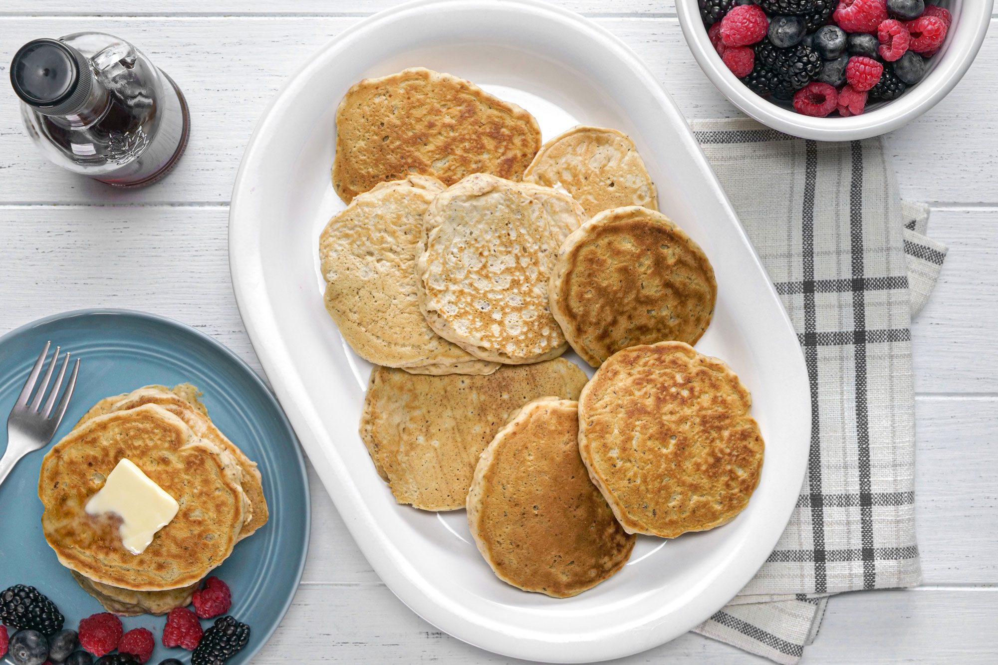 A plate of vegan pancakes served on a table with fresh berries