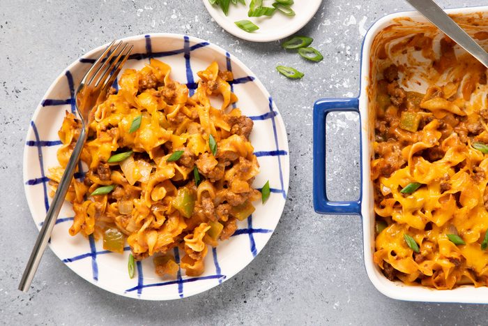 Beef And Noodle Casserole in a plate and a baking tray on a table