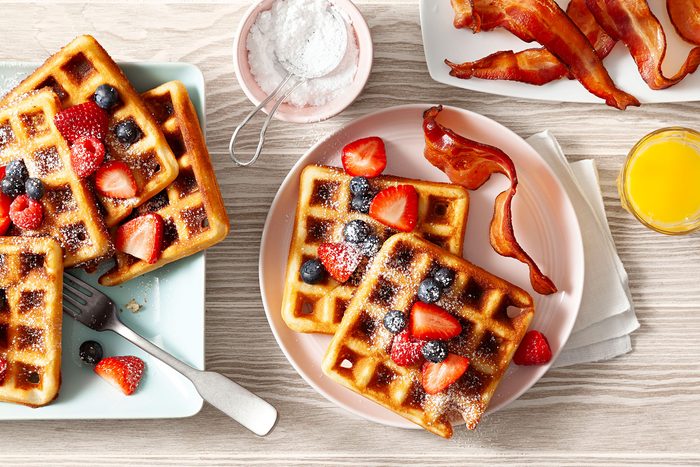 Belgian Waffles topped with fruits and served on plate