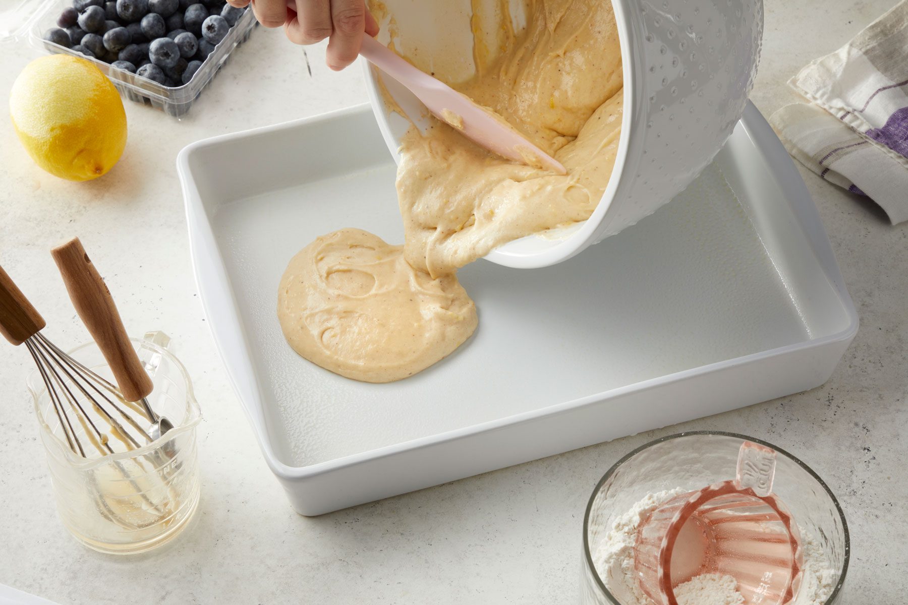 Pouring the Blueberry Kuchen mixture in a baking pan