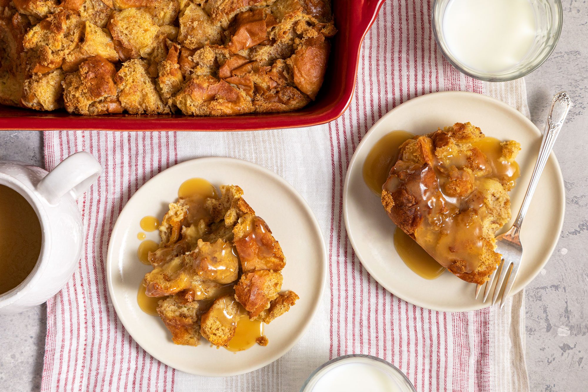 Bread Pudding Served in Two Small Plates with Vanilla Sauce