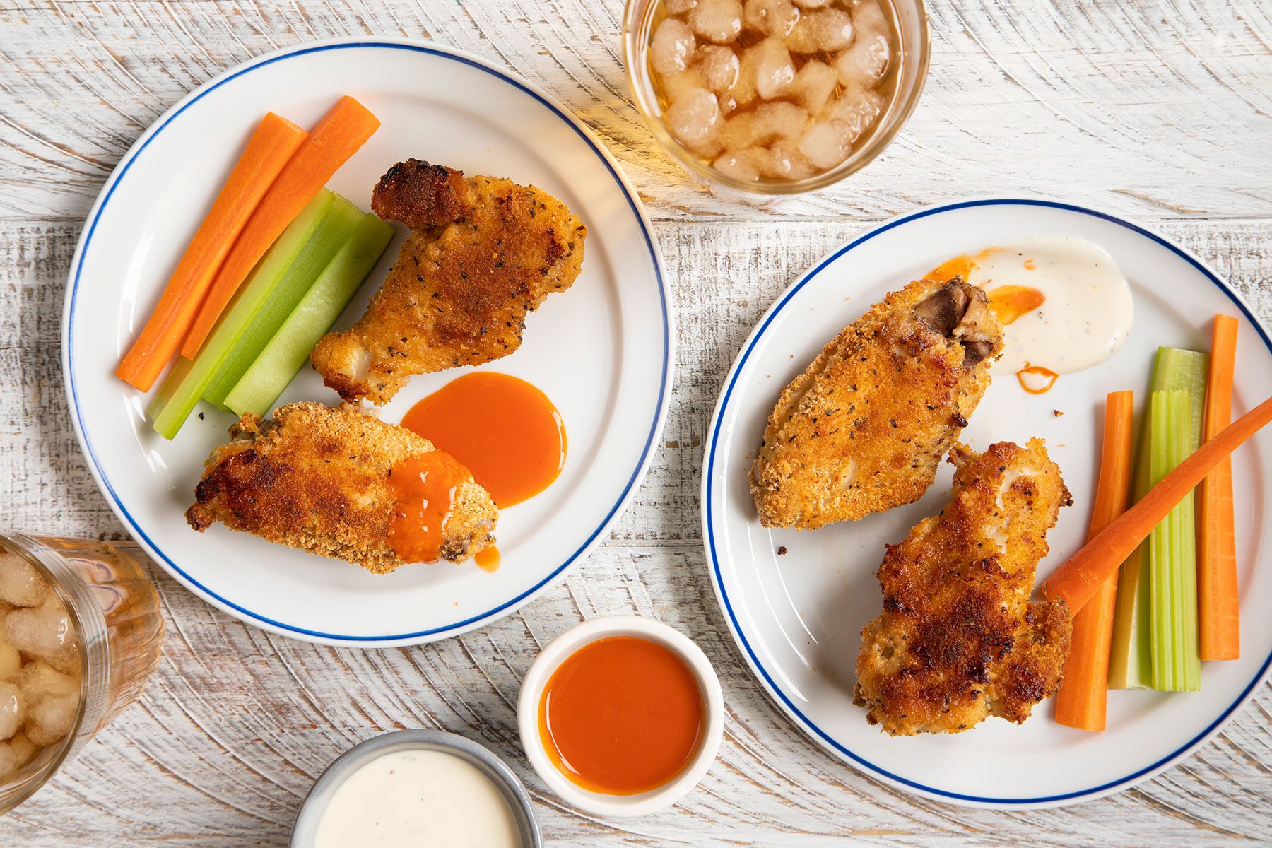 Chicken Wings served on plates with vegetables