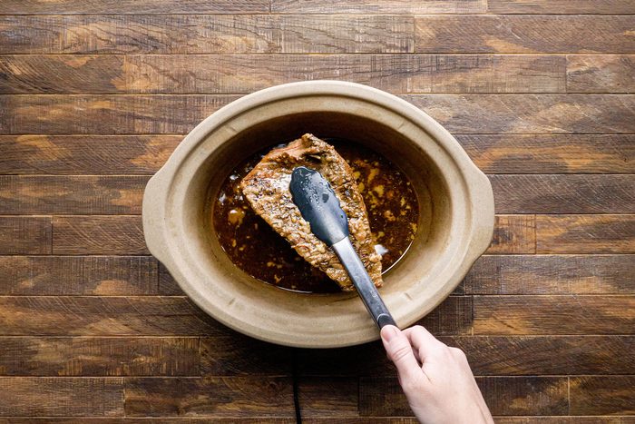 Skim the fat from cooking juices using tongs