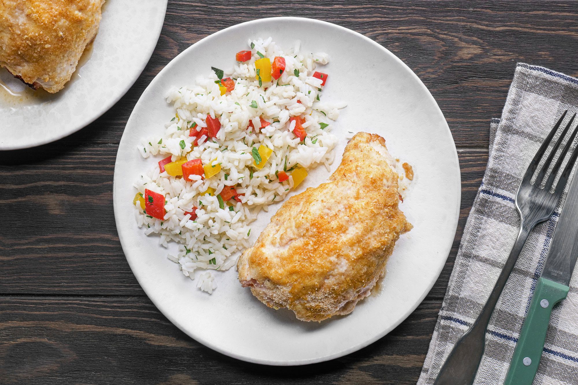 Chicken Cordon Bleu Served with Rice on a White Plate on Wooden Surface