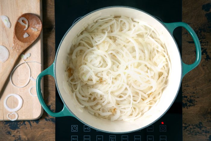 Cooking the onions in a dutch oven.