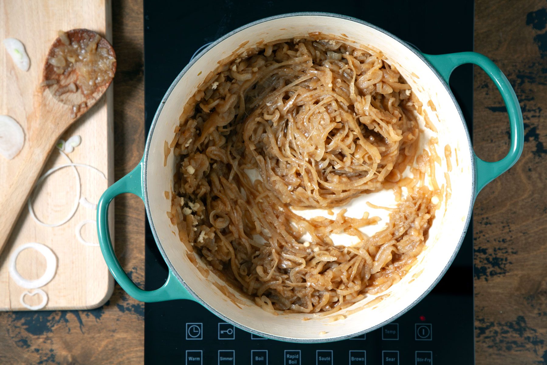 Caramelized onions being cooked in a dutch oven 