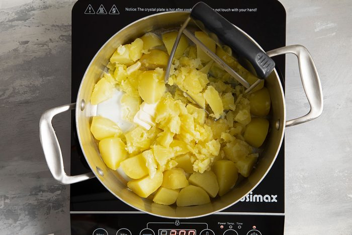 Mashing Potatoes in Saucepan over Induction stove