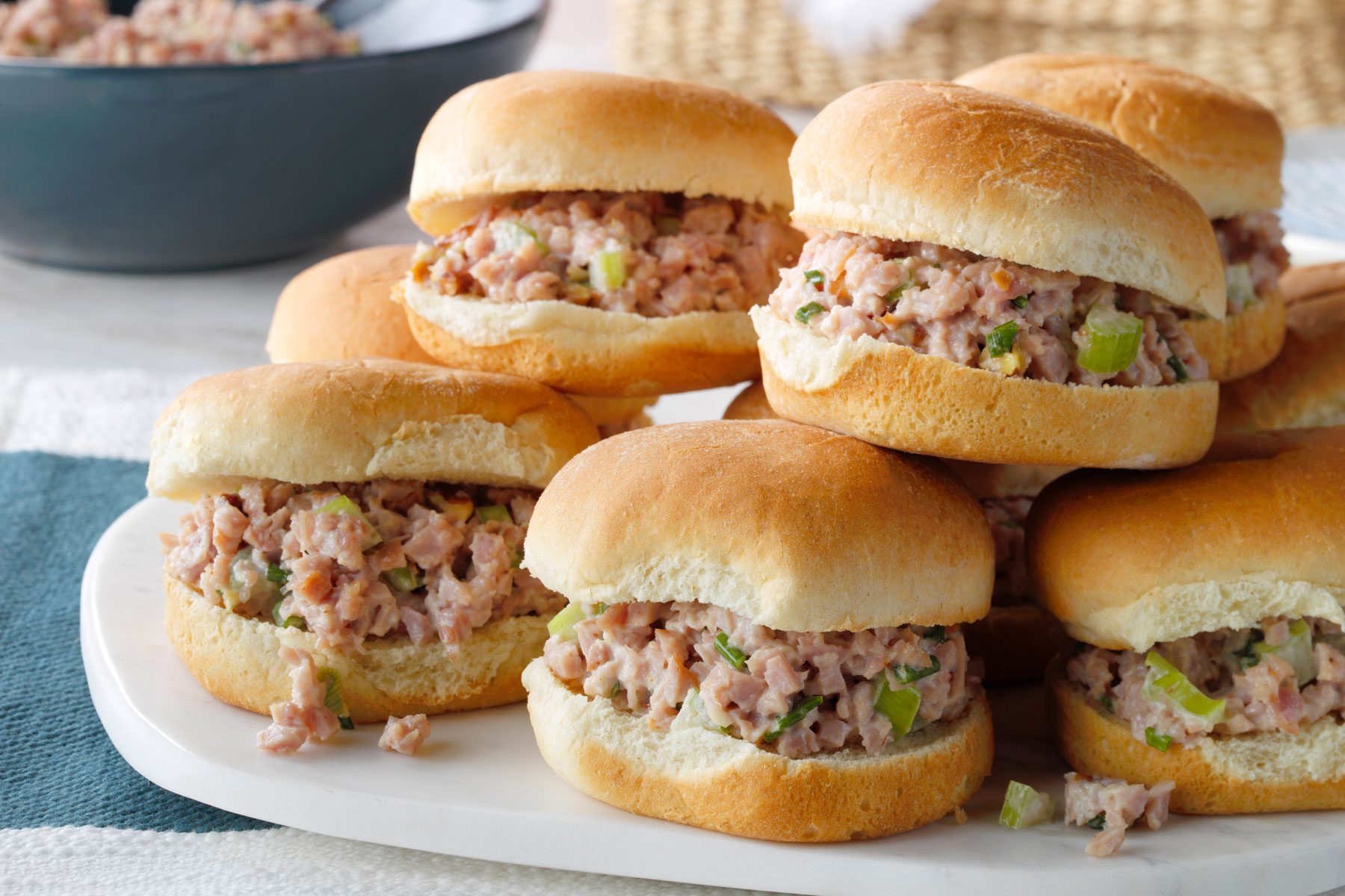 Ham Salad stuffed in burger bun served in a large plate.