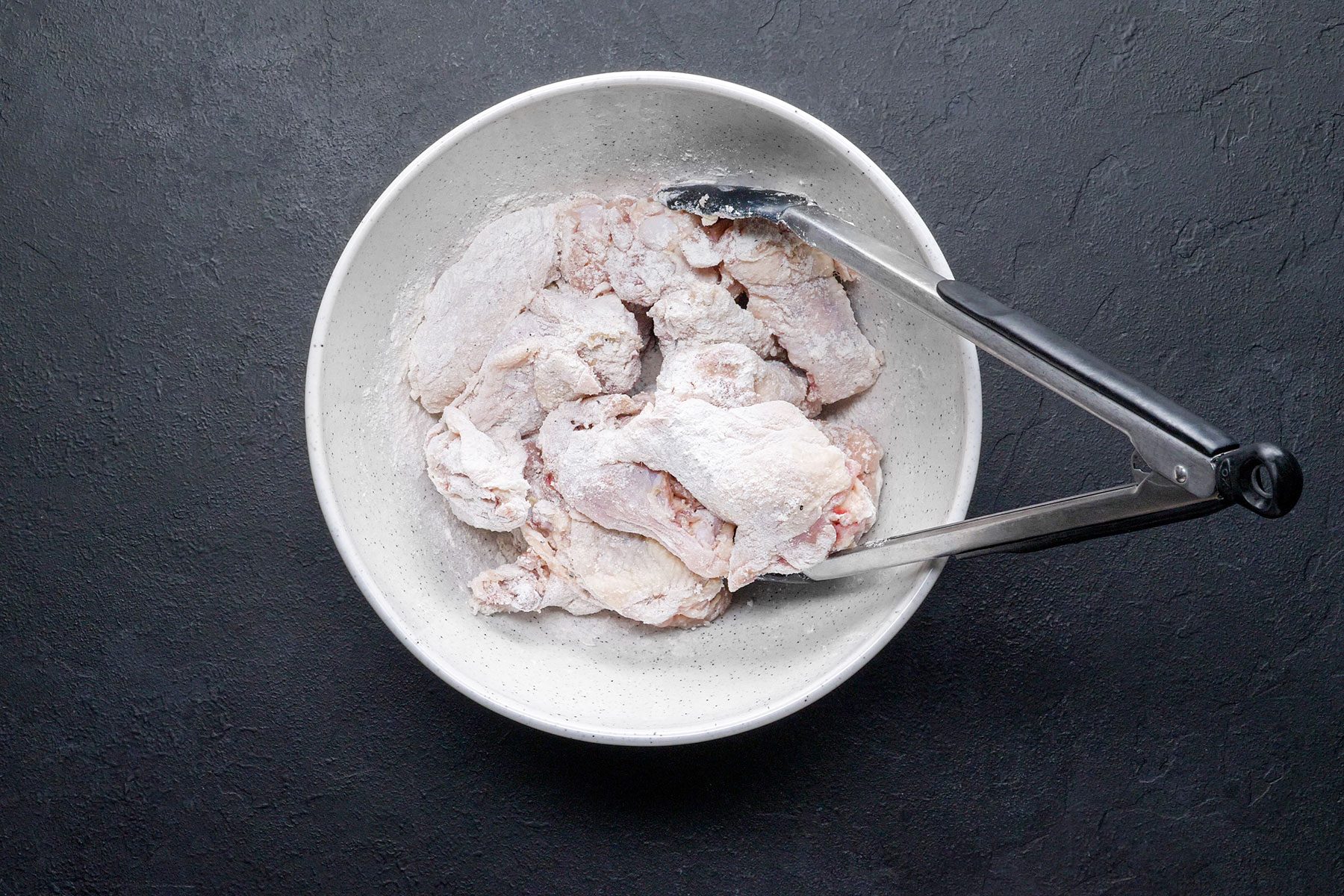 Coating Lemon Pepper Wings in flour
