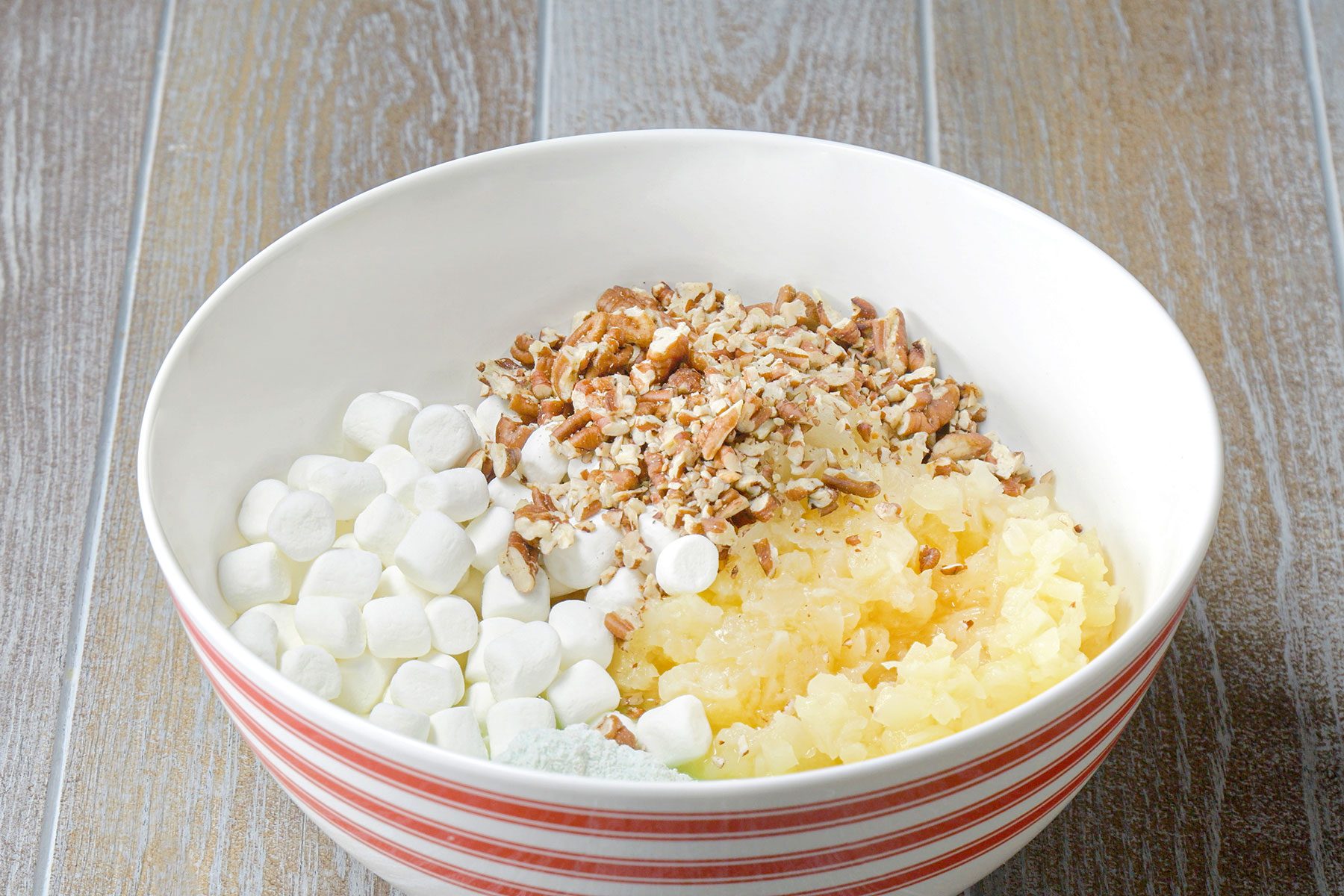 All ingredients for watergate salad in a large bowl