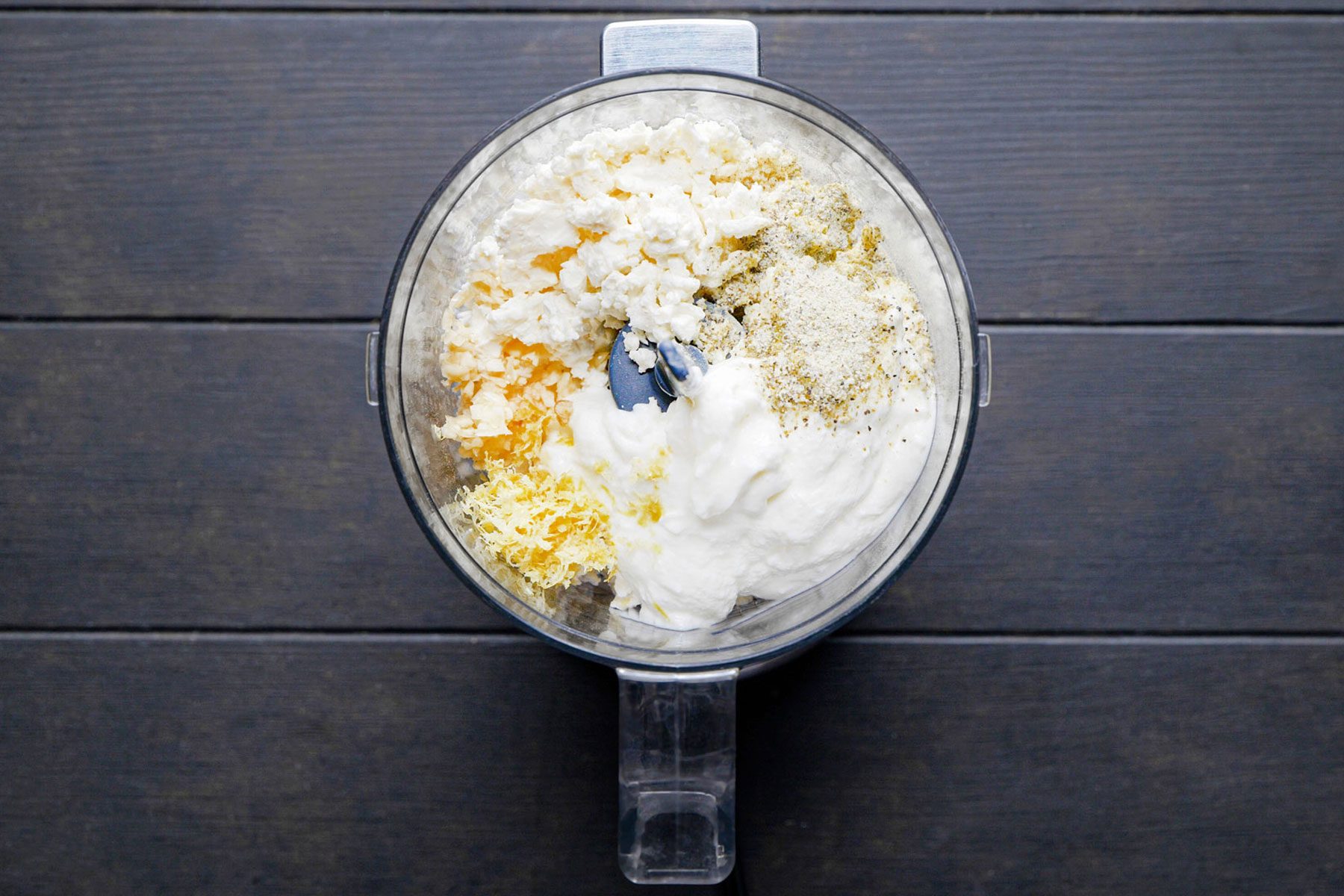 Ingredients to make Whipped Feta Dip mixed in a blender