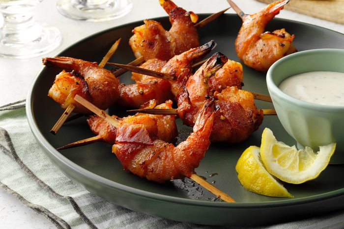 Bacon wrapped shrimp with with ranch dip and lemon wedges