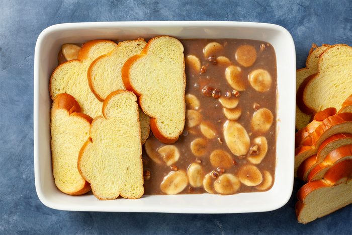 A bowl of food with bread and Banana