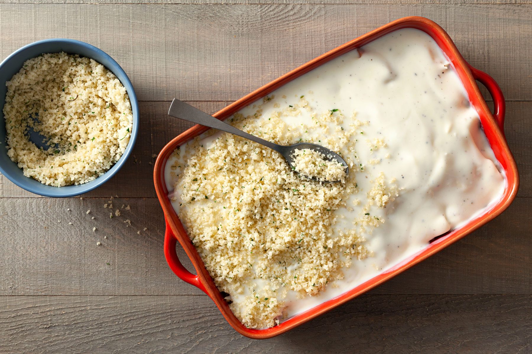 Break crumbs and a spoon the white sauce in a baking dish