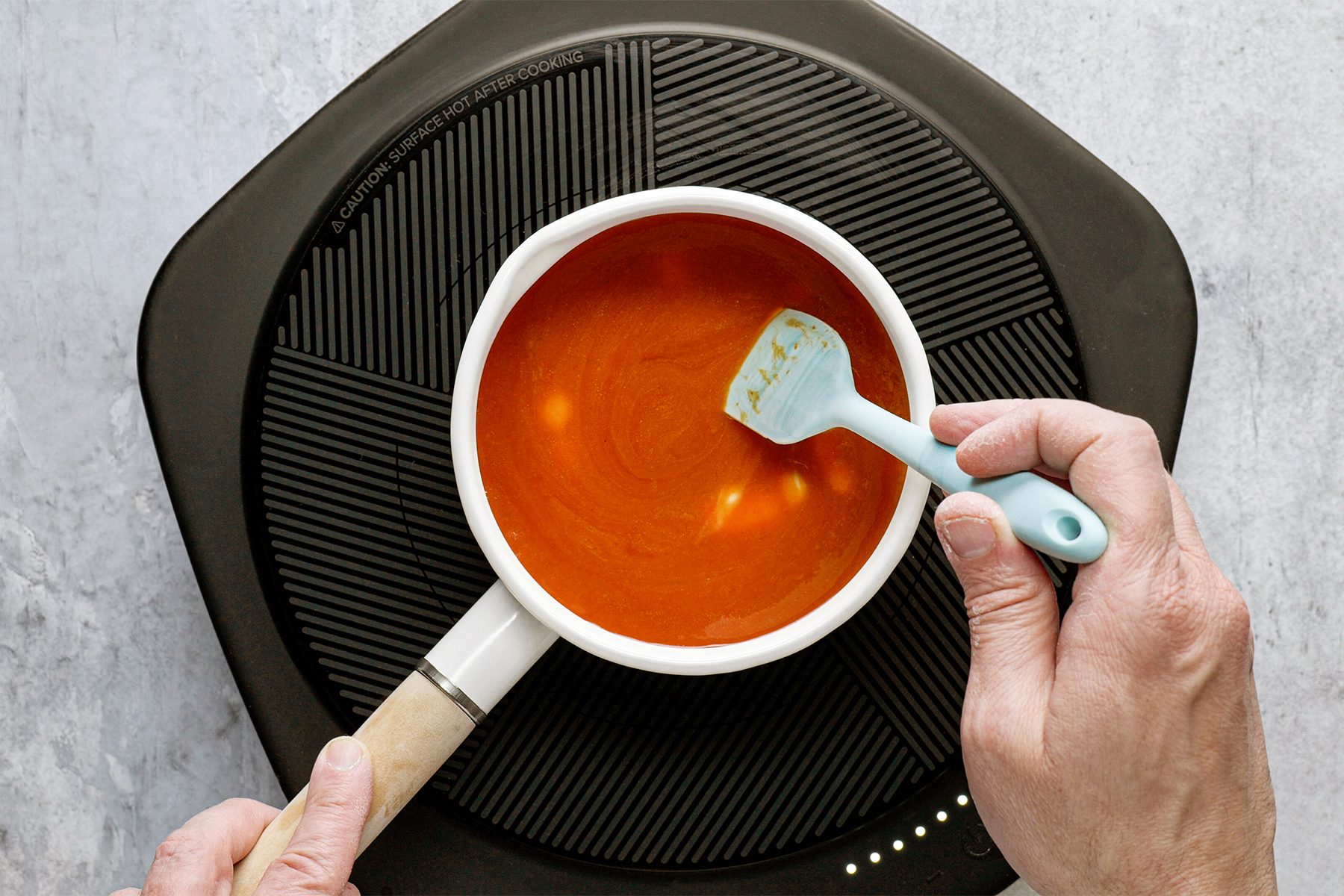 a person is cooking Buffalo sauce