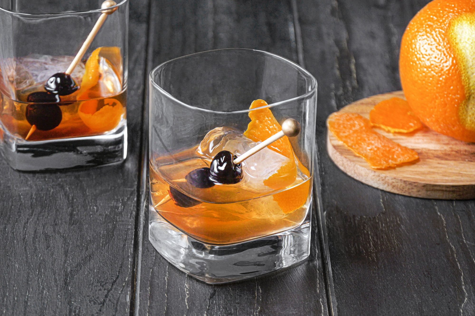 Old-Fashioned garnished with orange peel and cherries
