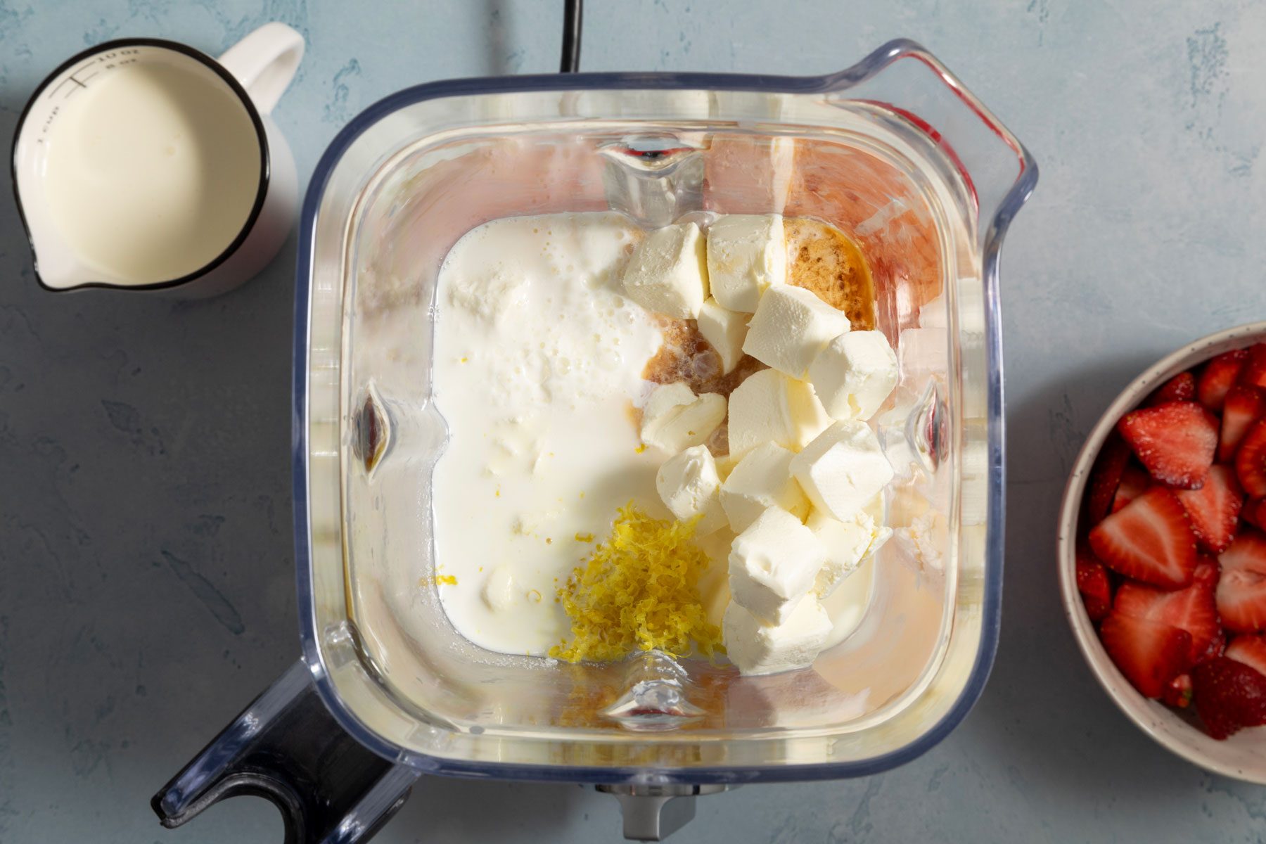 Lemon zest, lemon juice, sugar and cream cheese mixed in a blender