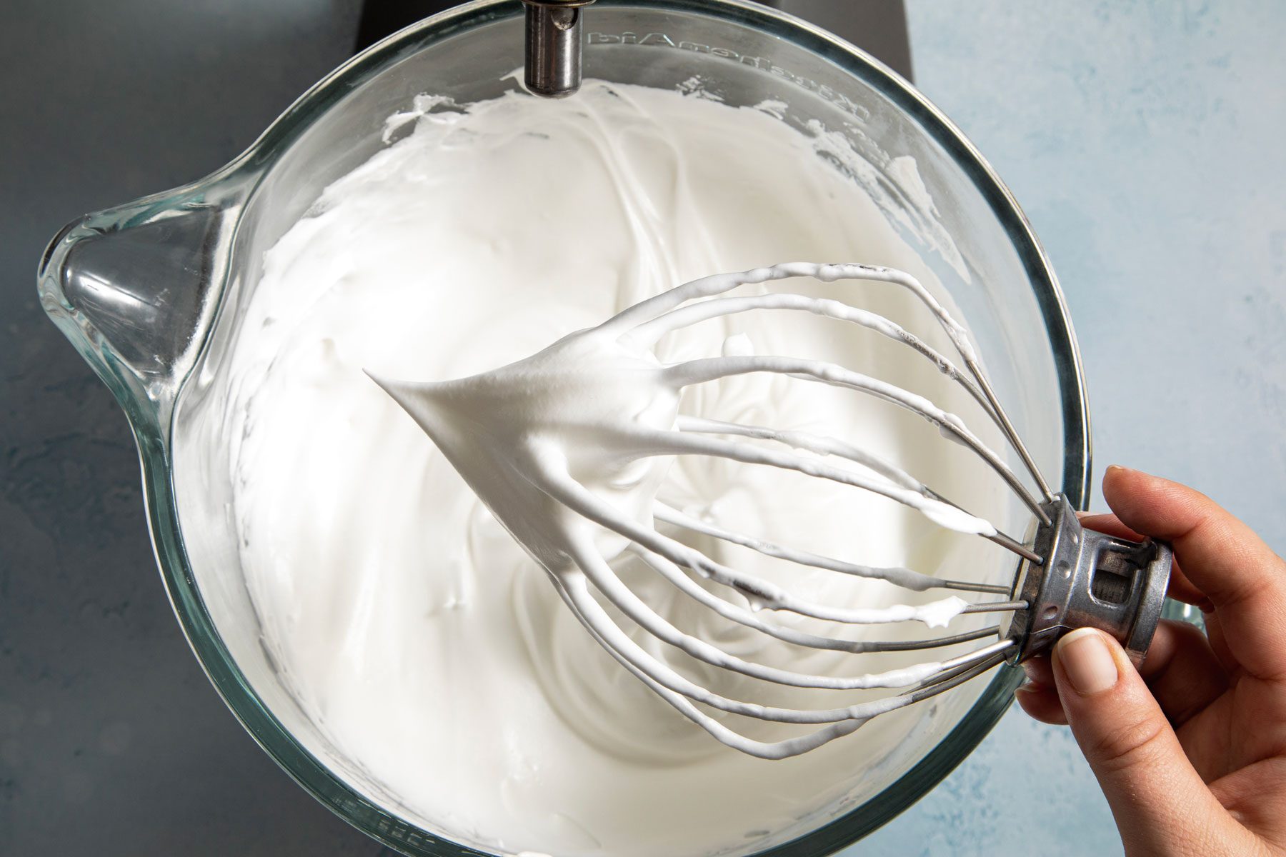 White foam in the blender jar on a kitchen countertop
