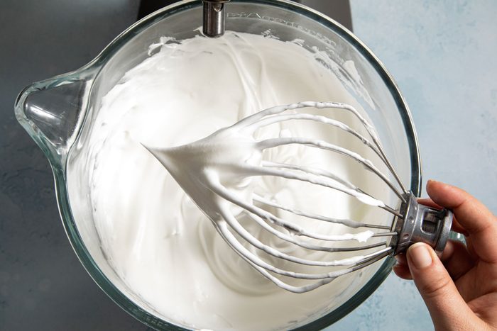 White foam in the blender jar on a kitchen countertop