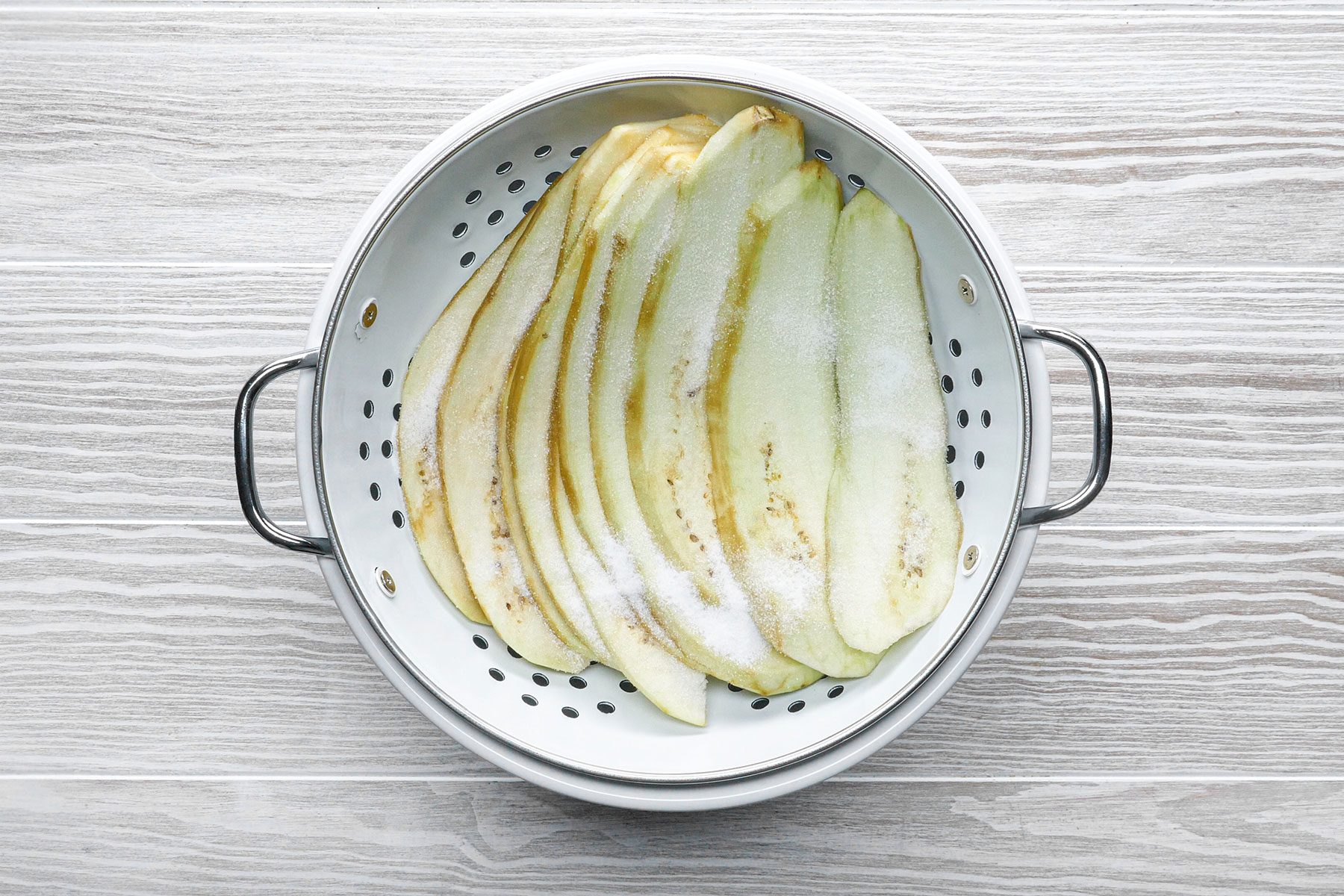 Slices of eggplant in colander