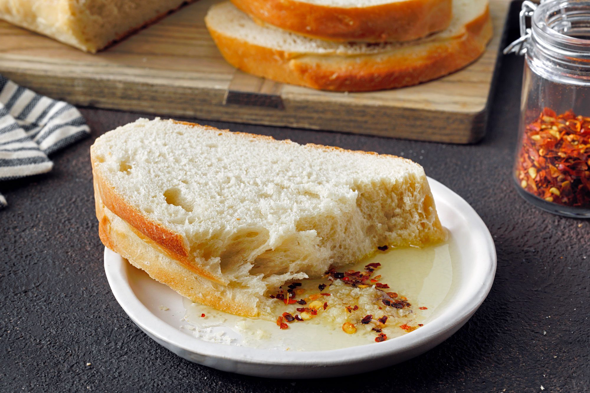 Mom's Italian Bread sliced and served with cilli flakes and cheese